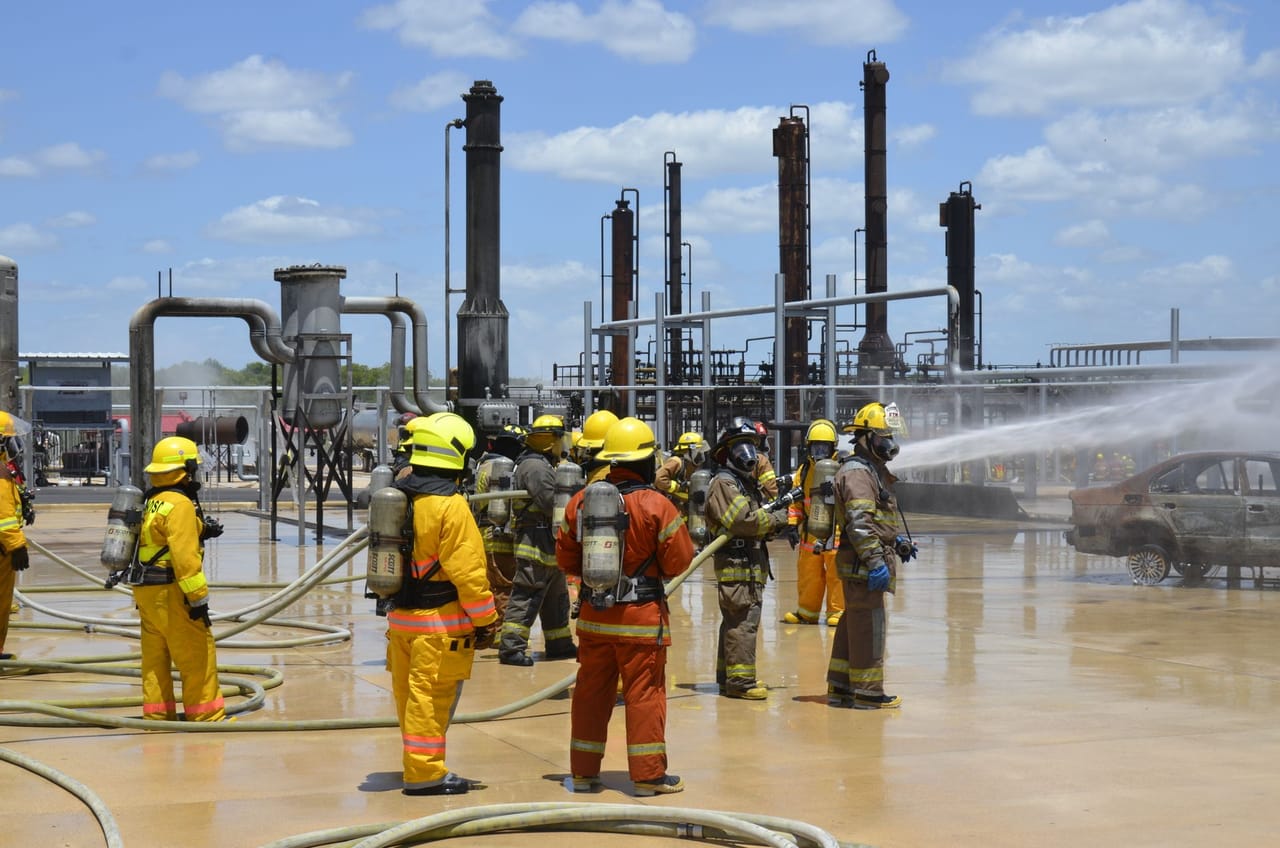 Firefighters advancing a charged hose line during a training evolution.